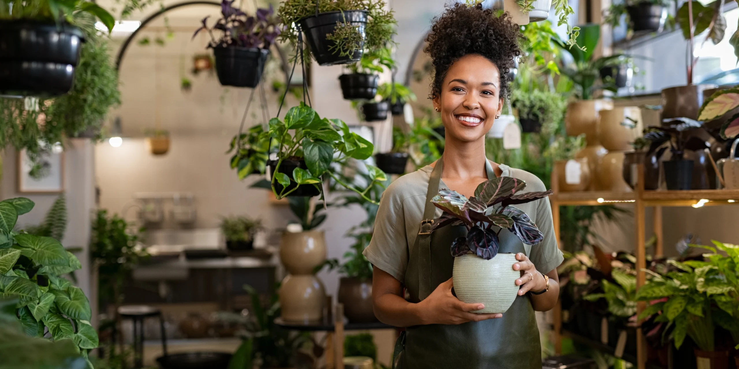 Small Business owner holding a plant